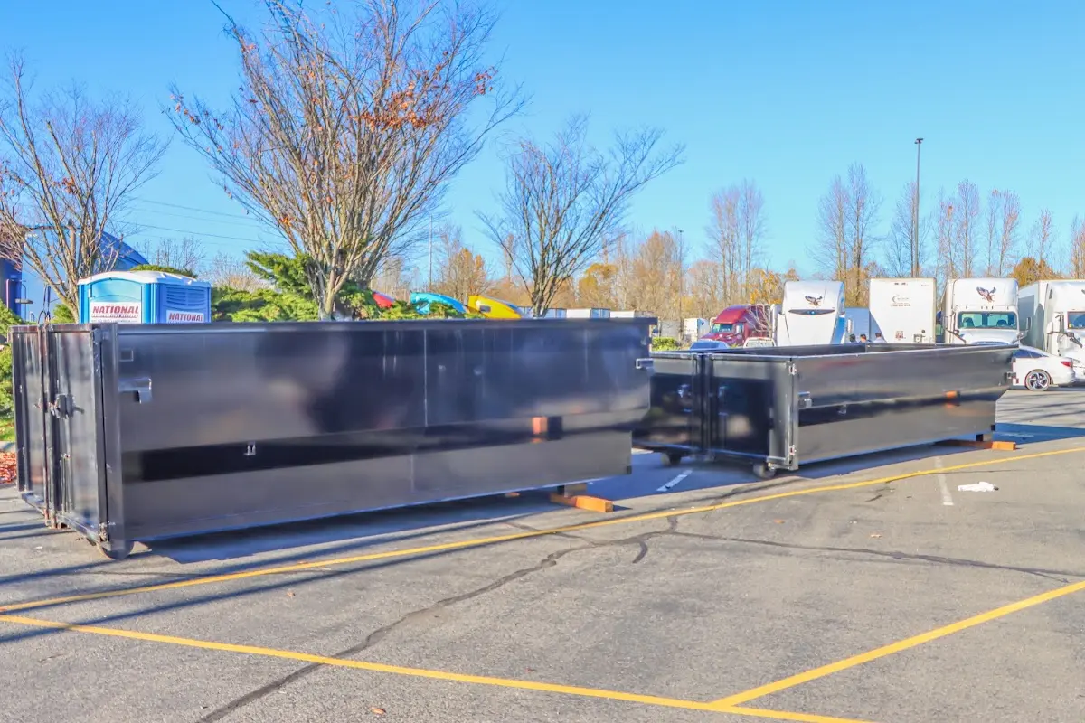 Professional dumpster rental service with roll-off container on residential driveway in Port Lavaca
